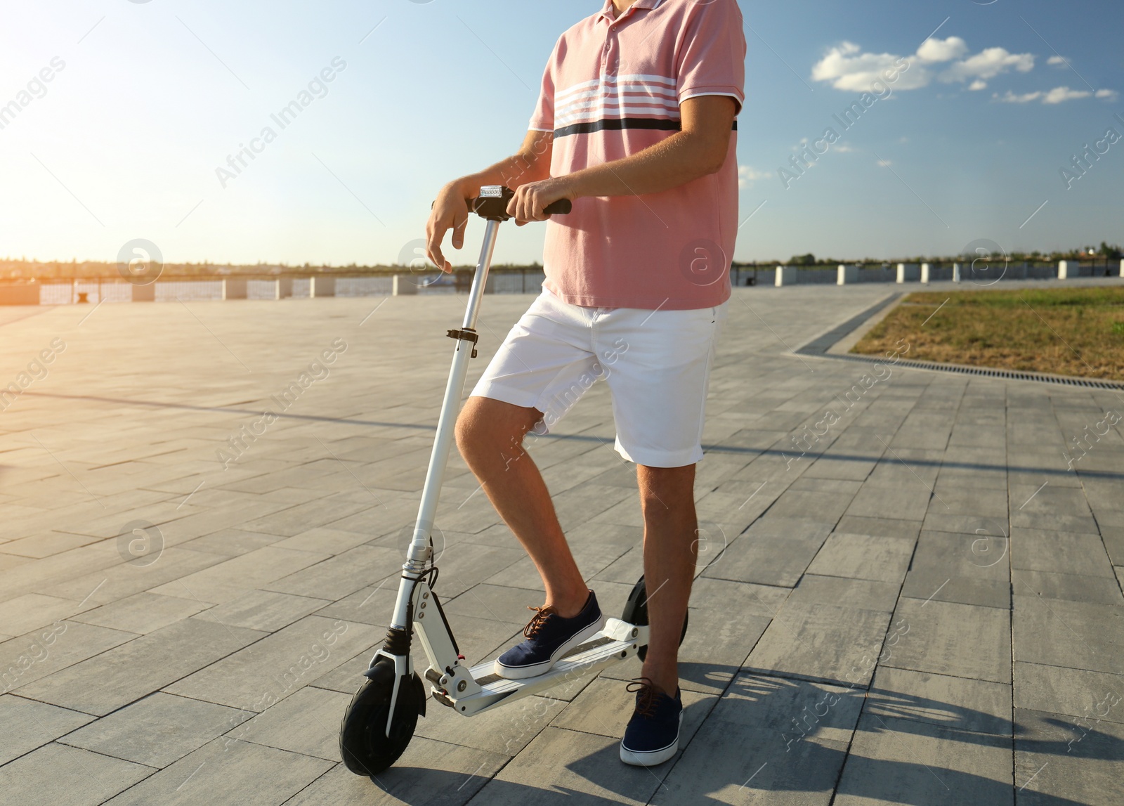 Man with modern kick scooter on waterfront, closeup Photo of Man with modern kick scooter on waterfront, closeup