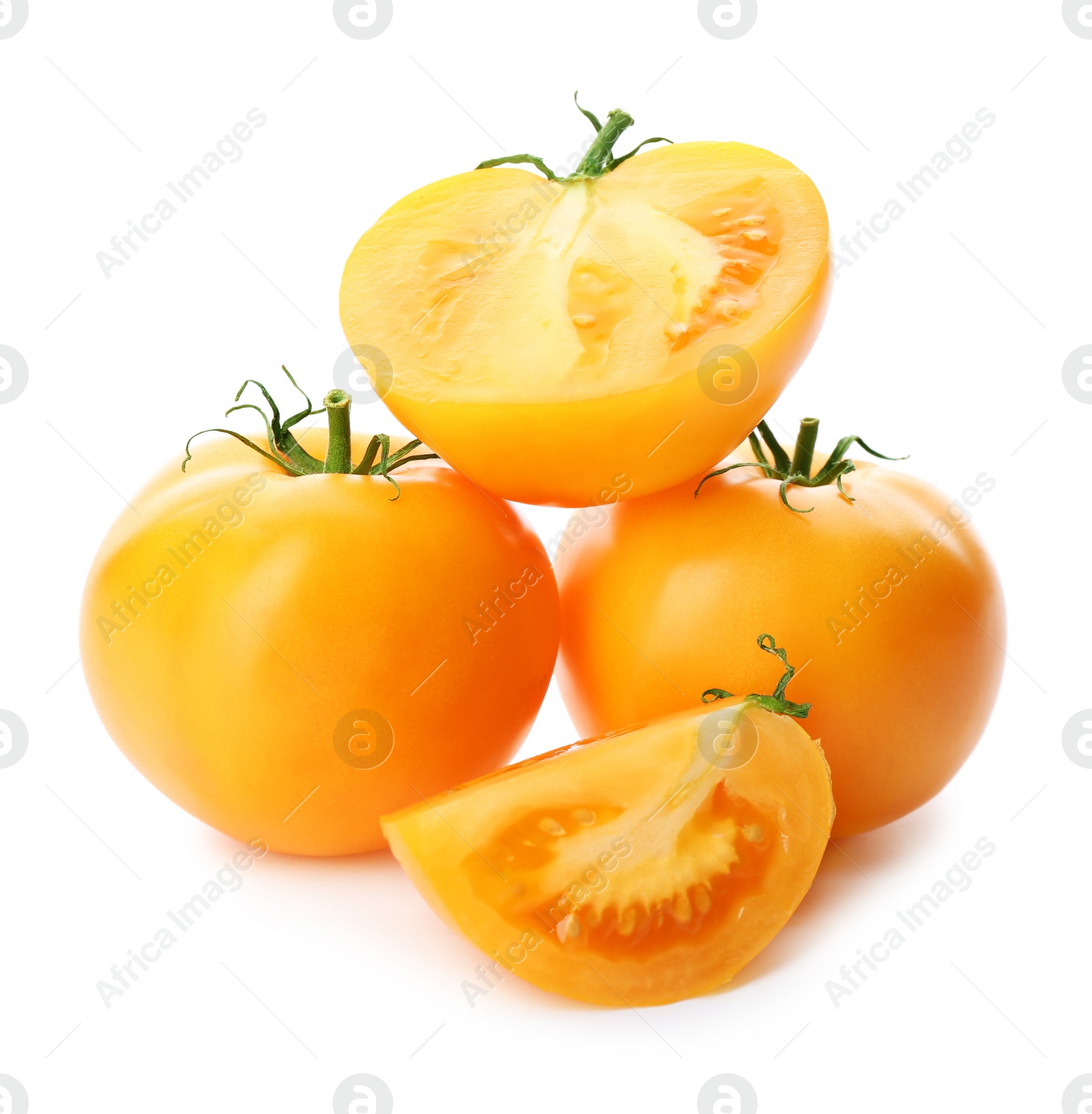 Cut ripe yellow tomatoes isolated on white Photo of Cut ripe yellow tomatoes isolated on white