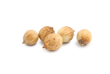 Photo of Scattered dried coriander seeds on white background, closeup