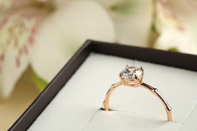 Beautiful engagement ring in box against blurred background, closeup. Space for text Photo of Beautiful engagement ring in box against blurred background, closeup. Space for text