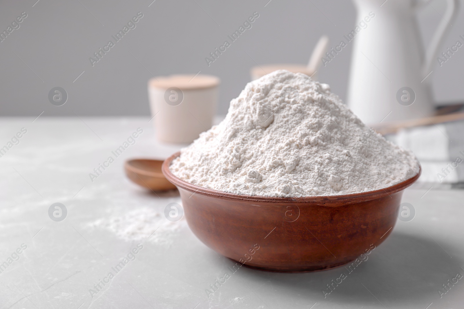 Wooden bowl with flour on table Photo of Wooden bowl with flour on table