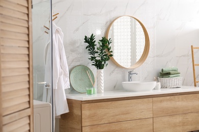 Modern bathroom interior with stylish mirror and vessel sink Photo of Modern bathroom interior with stylish mirror and vessel sink