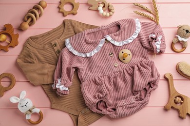 Flat lay composition with baby clothes and accessories on pink wooden background Photo of Flat lay composition with baby clothes and accessories on pink wooden background