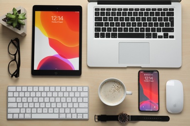 MYKOLAIV, UKRAINE - AUGUST 27, 2020: Flat lay composition with iPhone 11, MacBook laptop and iPad tablet on wooden table Photo of MYKOLAIV, UKRAINE - AUGUST 27, 2020: Flat lay composition with iPhone 11, MacBook laptop and iPad tablet on wooden table