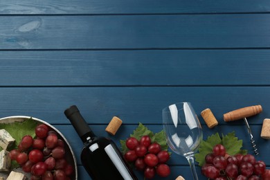 Tasty red wine and snacks on blue wooden table, flat lay. Space for text Photo of Tasty red wine and snacks on blue wooden table, flat lay. Space for text