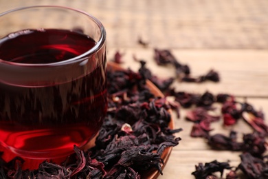 Fresh Hibiscus tea on wooden table, closeup Photo of Fresh Hibiscus tea on wooden table, closeup