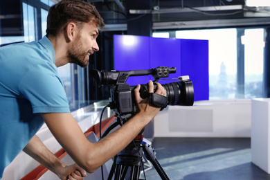 Photo of Professional video camera operator working in studio