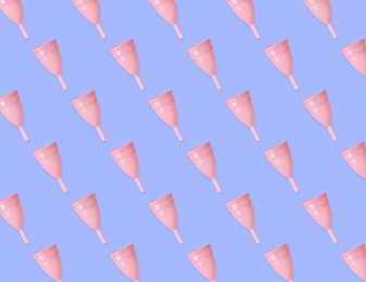 Image of Many pink menstrual cups on light blue background, flat lay. Pattern design