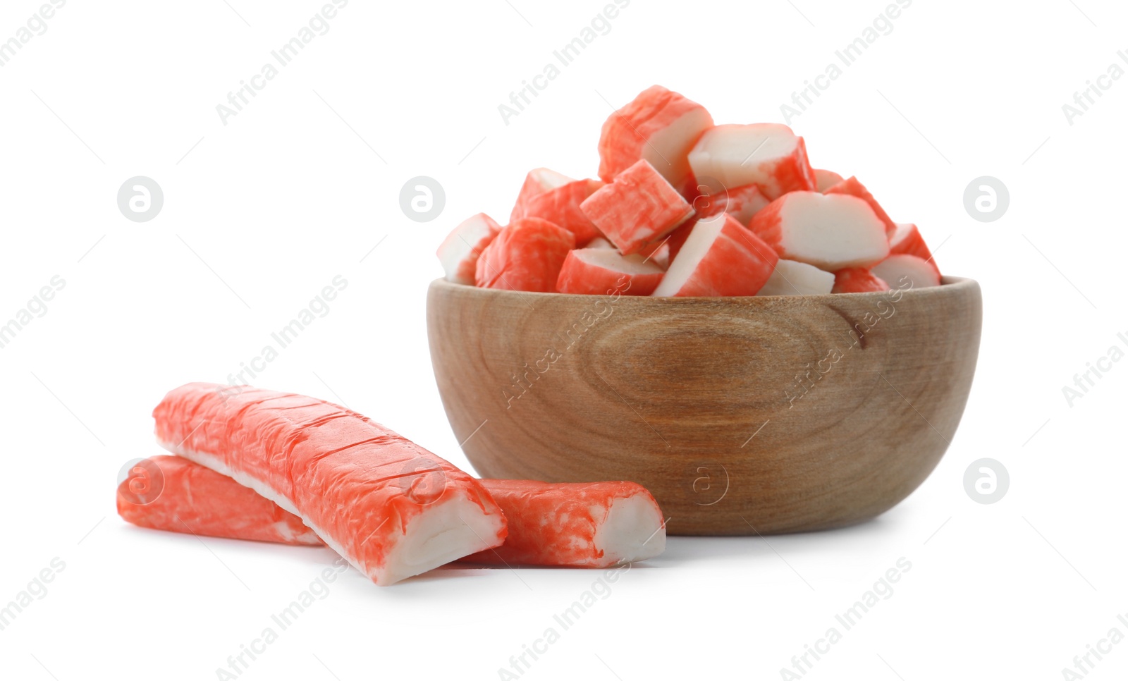 Photo of Cut crab sticks in wooden bowl on white background