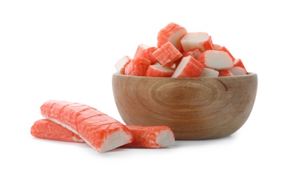 Cut crab sticks in wooden bowl on white background Photo of Cut crab sticks in wooden bowl on white background