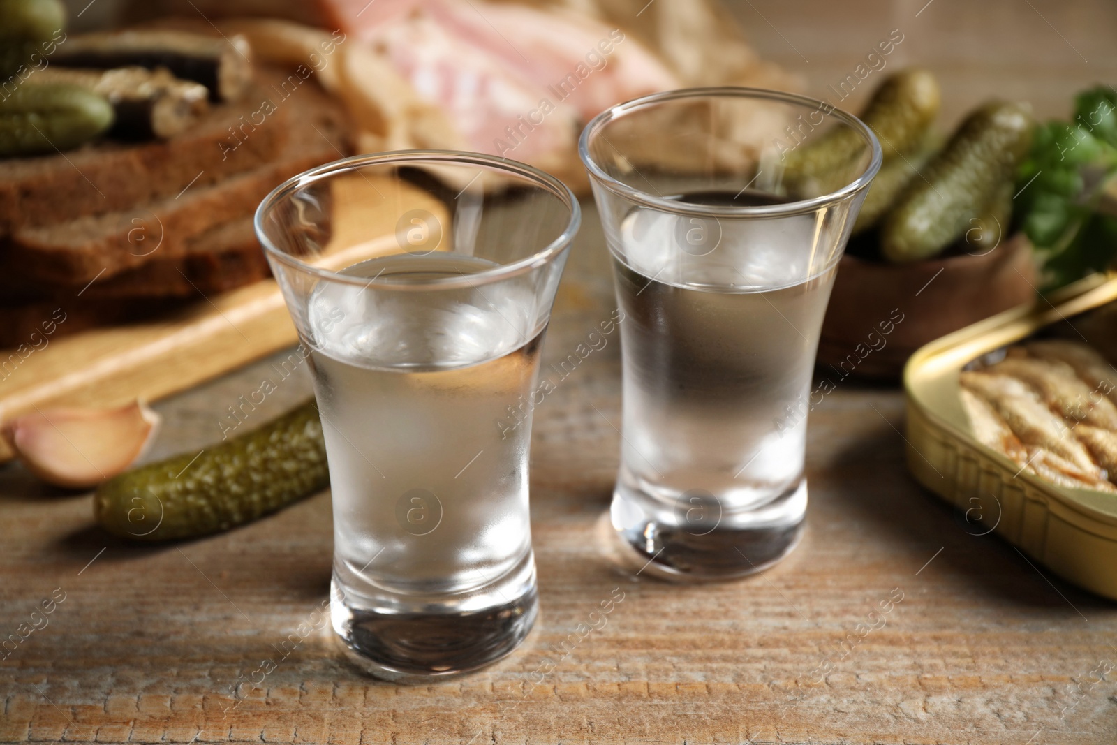 Cold Russian vodka with snacks on wooden table, closeup Photo of Cold Russian vodka with snacks on wooden table, closeup