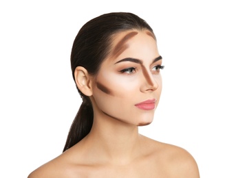 Young woman with contouring lines on her face against white background. Professional makeup products Photo of Young woman with contouring lines on her face against white background. Professional makeup products