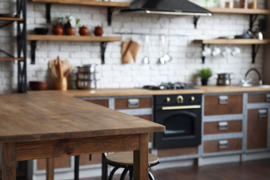 Empty wooden table in beautiful kitchen. Interior design Photo of Empty wooden table in beautiful kitchen. Interior design