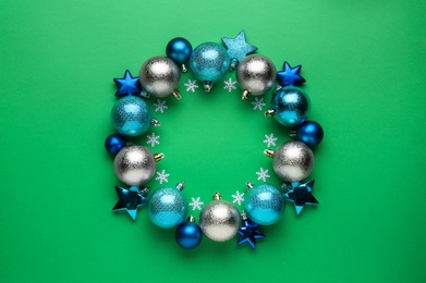 Beautiful festive wreath made of different Christmas balls on green background, top view Photo of Beautiful festive wreath made of different Christmas balls on green background, top view