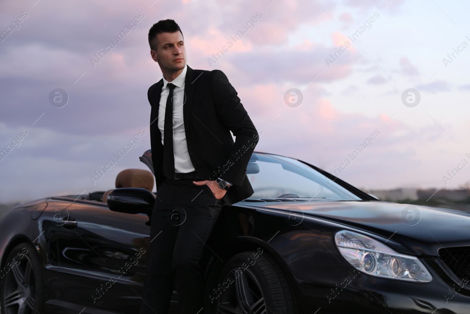 Handsome businessman near luxury convertible car outdoors Photo of Handsome businessman near luxury convertible car outdoors