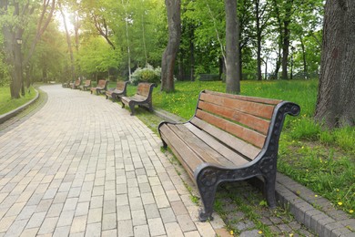 Beautiful view of city park with benches on spring day Photo of Beautiful view of city park with benches on spring day