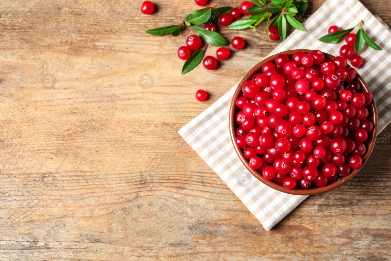 Tasty ripe cranberries on wooden table, flat lay. Space for text Photo of Tasty ripe cranberries on wooden table, flat lay. Space for text