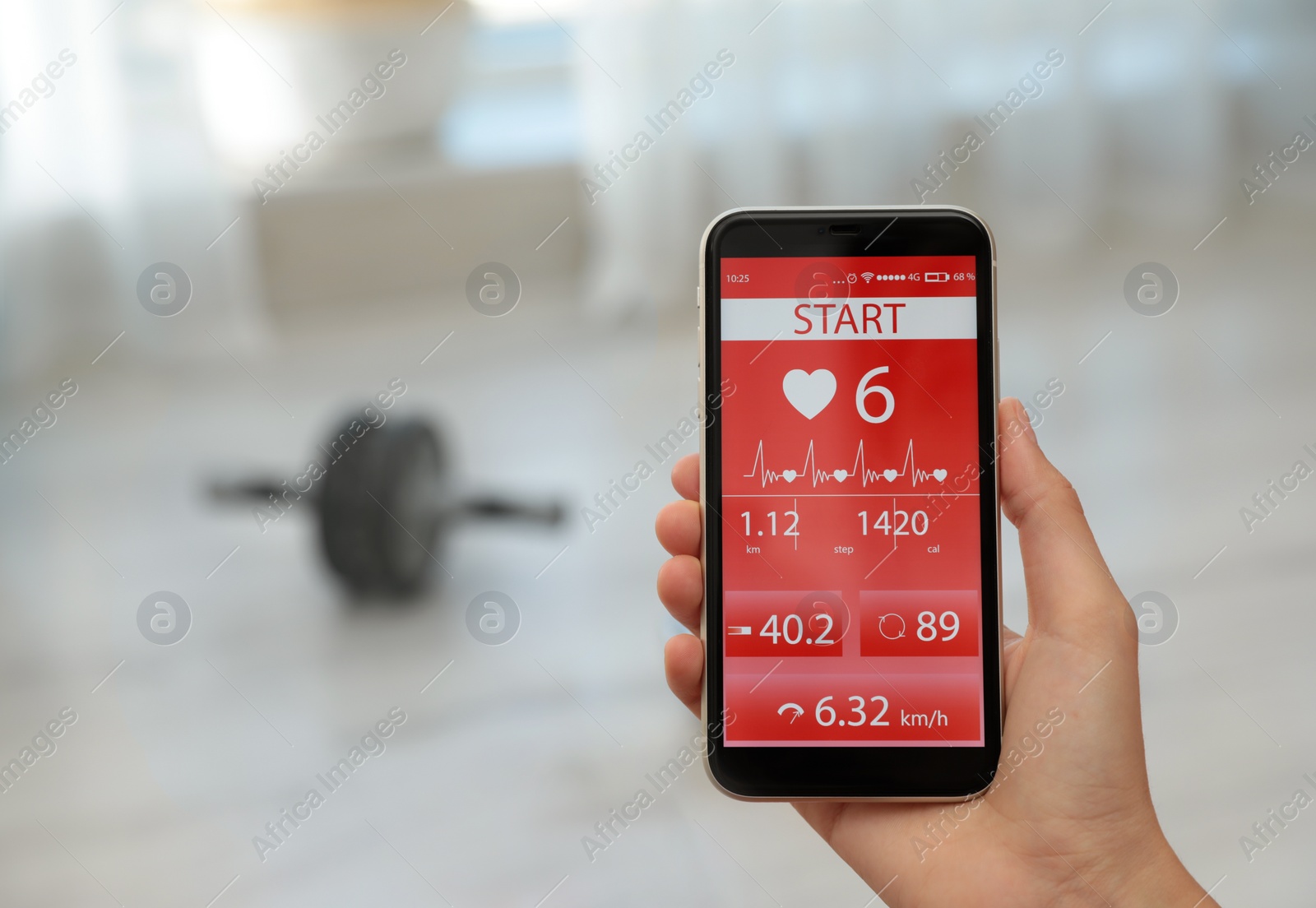 Young woman using fitness app on smartphone indoors, closeup. Space for text Photo of Young woman using fitness app on smartphone indoors, closeup. Space for text