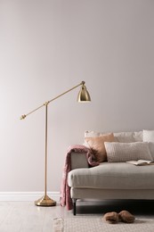 Stylish living room interior with comfortable sofa and floor lamp. Space for text Photo of Stylish living room interior with comfortable sofa and floor lamp. Space for text