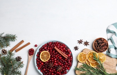 Flat lay composition with fresh ripe cranberries on white wooden table. Space for text Photo of Flat lay composition with fresh ripe cranberries on white wooden table. Space for text