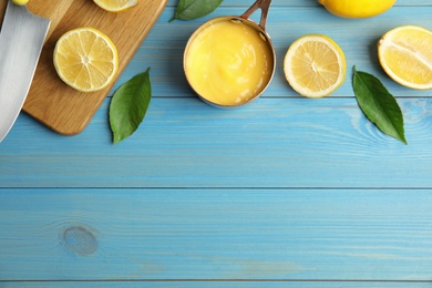 Delicious lemon curd and fresh fruits on light blue wooden table, flat lay. Space for text Photo of Delicious lemon curd and fresh fruits on light blue wooden table, flat lay. Space for text