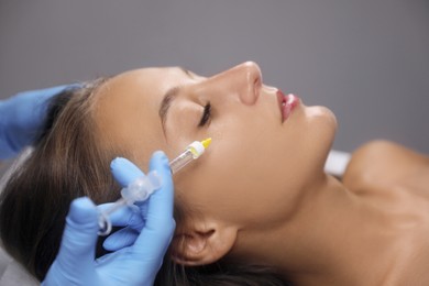 Beautiful woman getting facial injection in salon Photo of Beautiful woman getting facial injection in salon