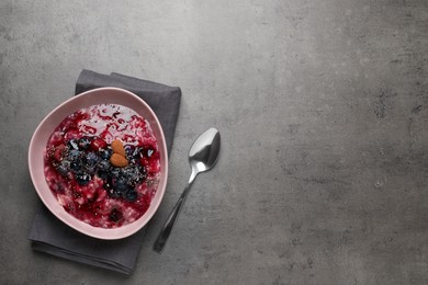 Tasty oatmeal porridge with toppings on grey table, flat lay. Space for text Photo of Tasty oatmeal porridge with toppings on grey table, flat lay. Space for text