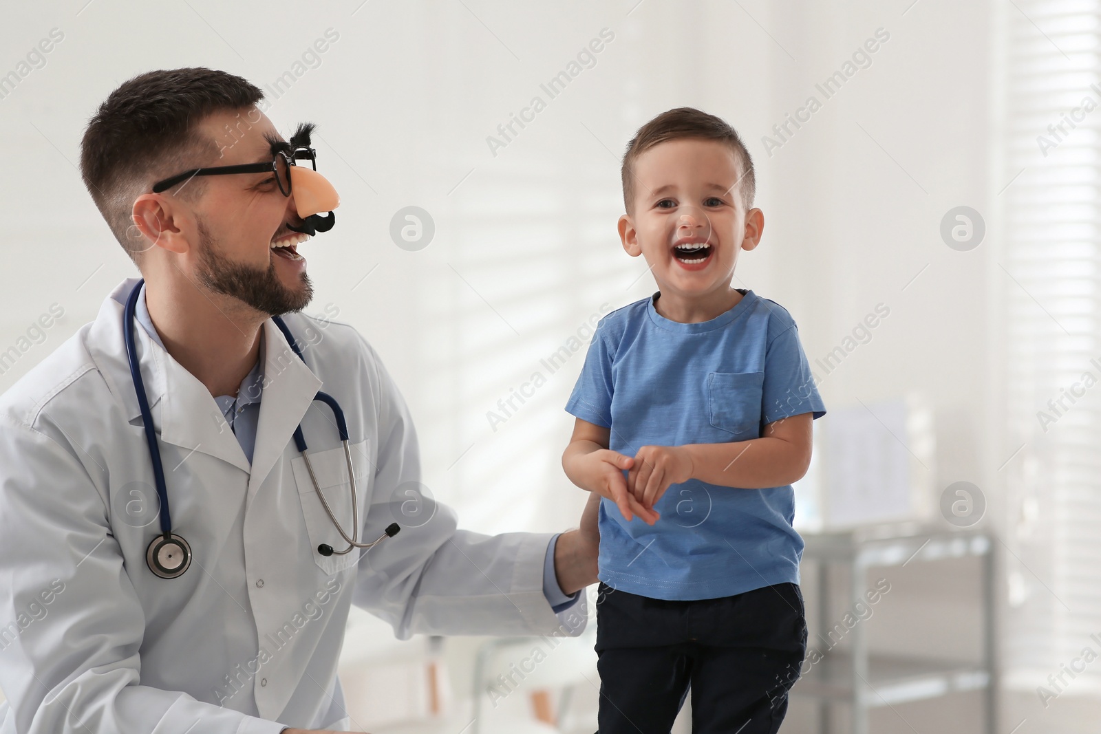 Pediatrician playing with little boy at hospital Photo of Pediatrician playing with little boy at hospital