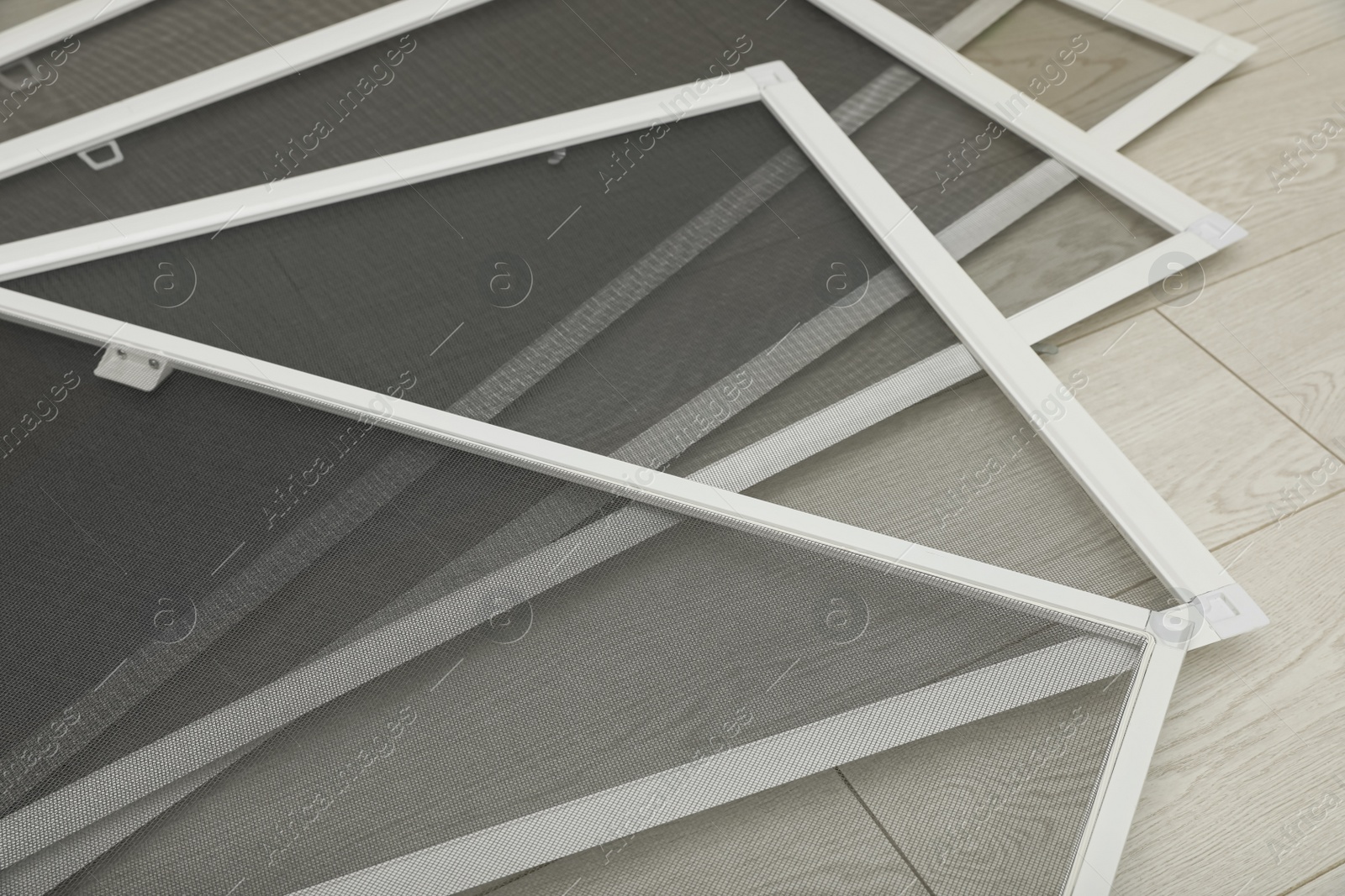 Set of window screens on wooden floor, closeup Photo of Set of window screens on wooden floor, closeup