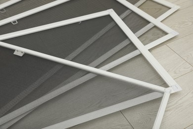 Set of window screens on wooden floor, closeup Photo of Set of window screens on wooden floor, closeup