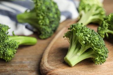 Fresh green broccoli on wooden table, closeup. Organic food Photo of Fresh green broccoli on wooden table, closeup. Organic food