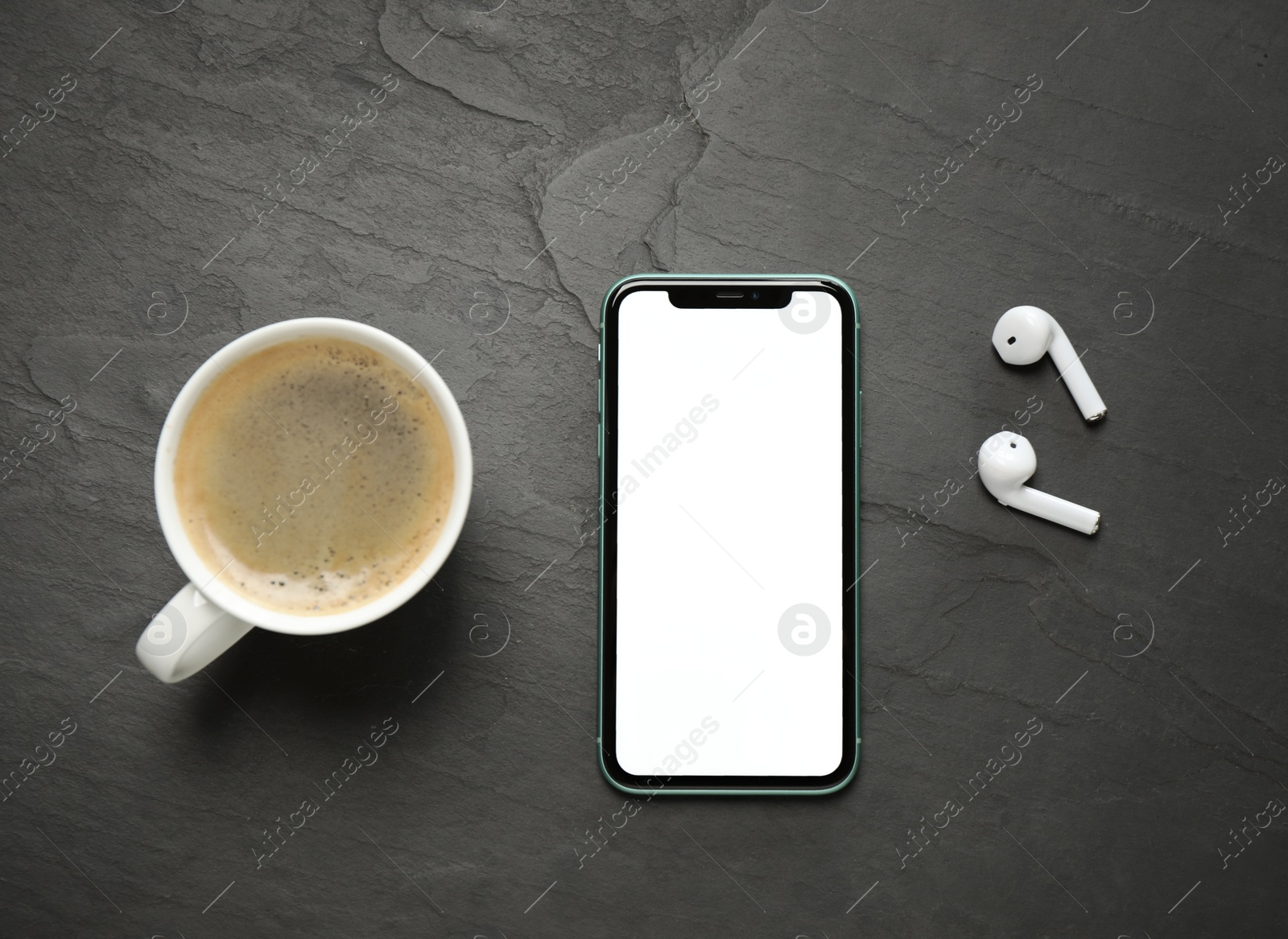 MYKOLAIV, UKRAINE - JULY 8, 2020: Iphone 11 Pro Max with blank screen, cup of coffee and earphones on black background, flat lay Photo of MYKOLAIV, UKRAINE - JULY 8, 2020: Iphone 11 Pro Max with blank screen, cup of coffee and earphones on black background, flat lay