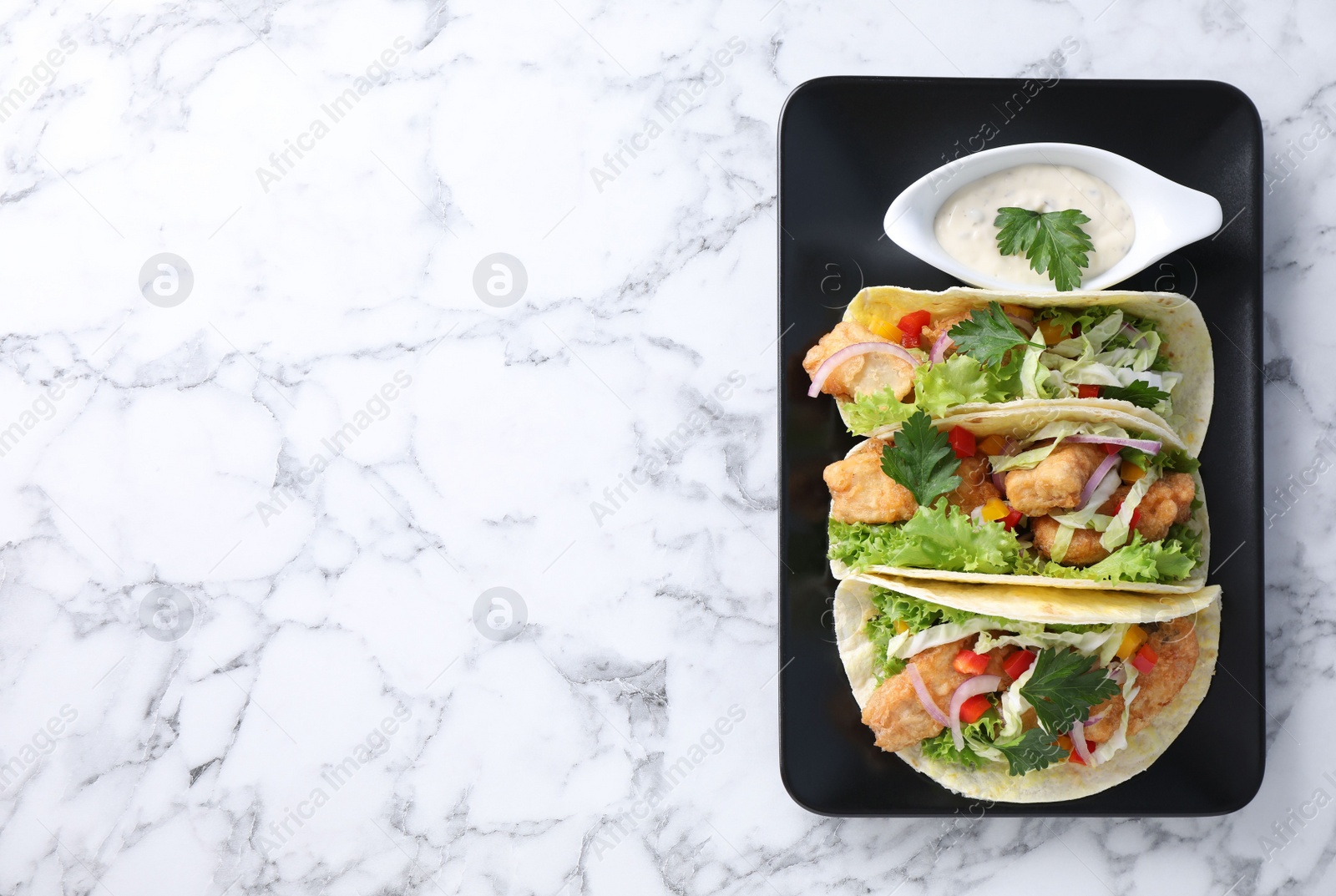 Yummy fish tacos served on white marble table, top view. Space for text Photo of Yummy fish tacos served on white marble table, top view. Space for text