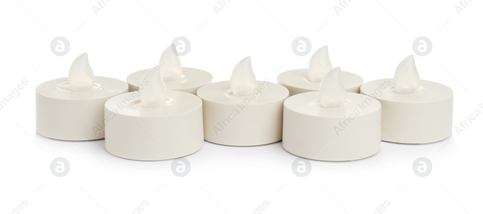 Decorative flameless LED candles on white background Photo of Decorative flameless LED candles on white background