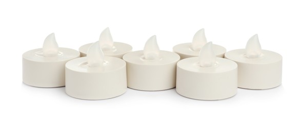 Decorative flameless LED candles on white background Photo of Decorative flameless LED candles on white background