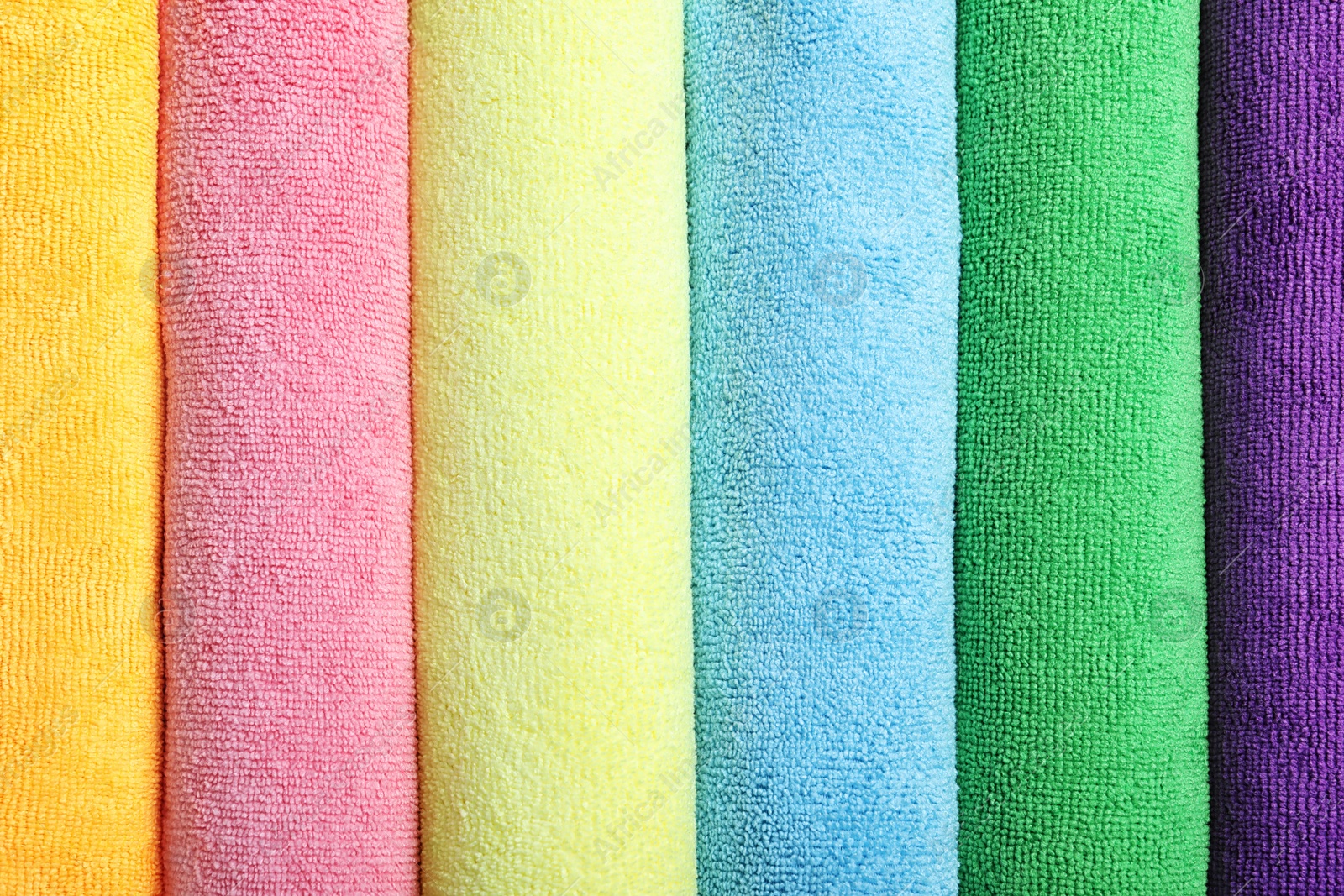 Many colorful microfiber cloths as background, top view Photo of Many colorful microfiber cloths as background, top view