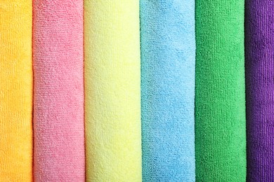 Many colorful microfiber cloths as background, top view Photo of Many colorful microfiber cloths as background, top view