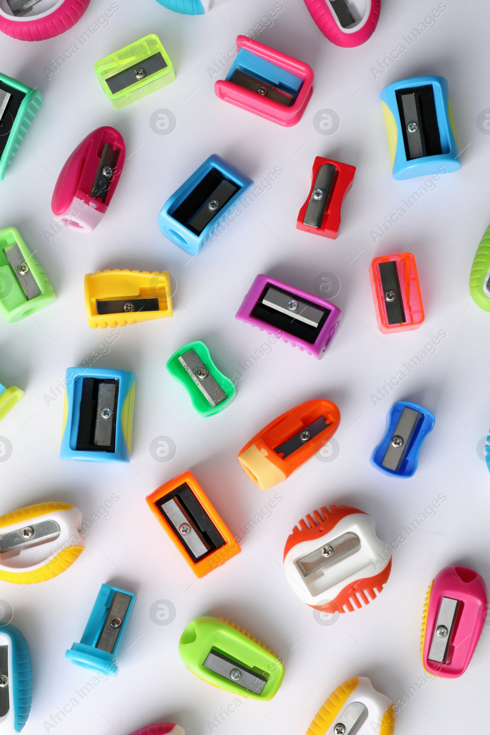 Many different colorful sharpeners on white background, flat lay. Diversity concept Photo of Many different colorful sharpeners on white background, flat lay. Diversity concept
