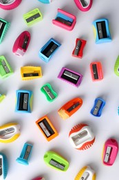 Many different colorful sharpeners on white background, flat lay. Diversity concept Photo of Many different colorful sharpeners on white background, flat lay. Diversity concept