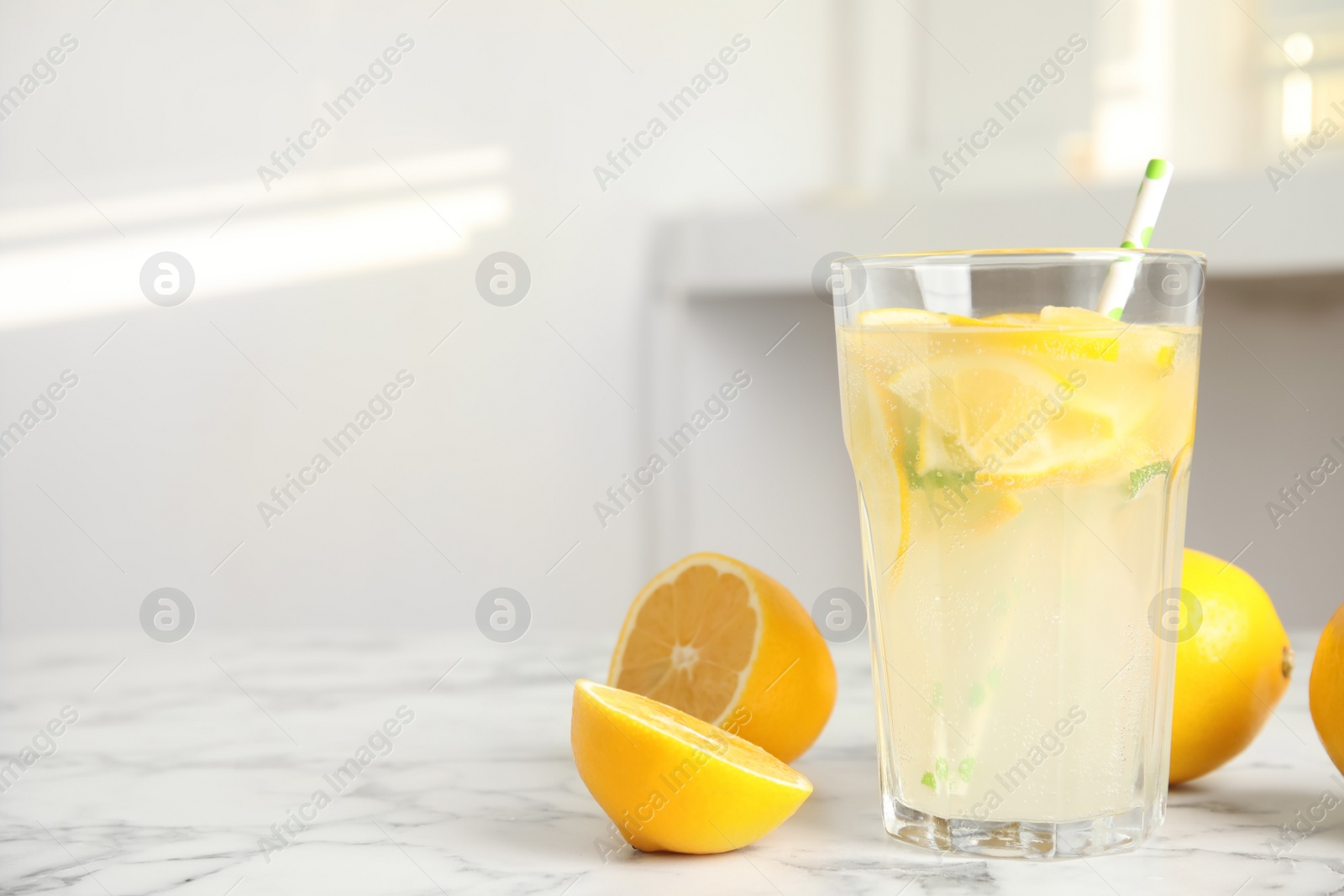 Cool freshly made lemonade and fruits on white marble table. space for text Photo of Cool freshly made lemonade and fruits on white marble table. space for text