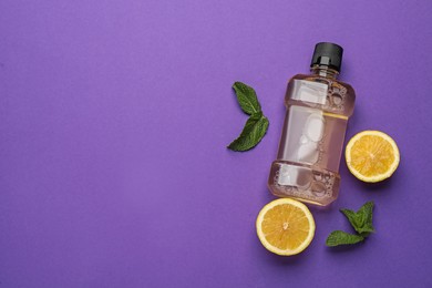 Mouthwash, fresh mint and lemon on purple background, flat lay. Space for text Photo of Mouthwash, fresh mint and lemon on purple background, flat lay. Space for text