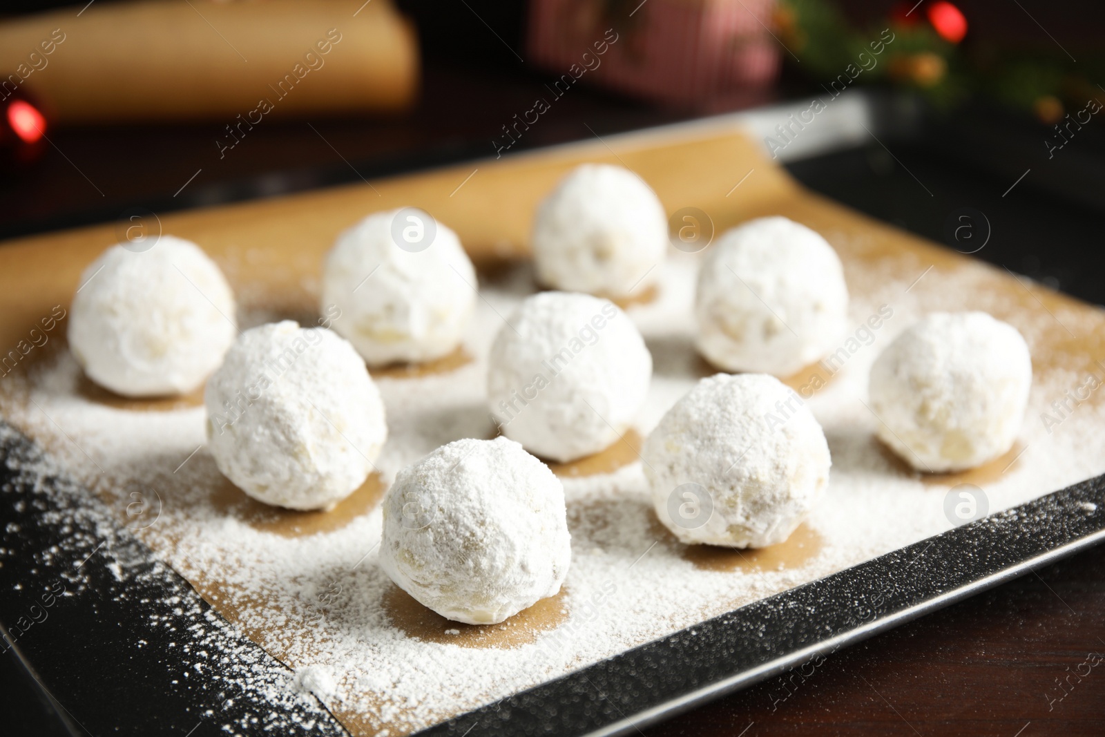 Photo of Christmas snowball cookies on baking tray, closeup