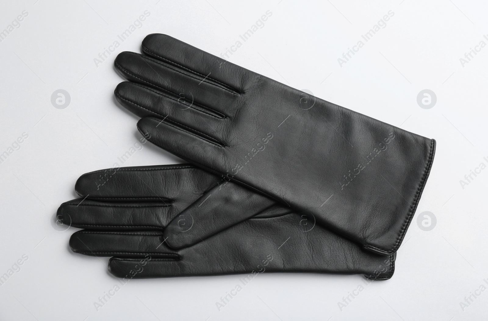 Pair of stylish leather gloves on white background, flat lay Photo of Pair of stylish leather gloves on white background, flat lay
