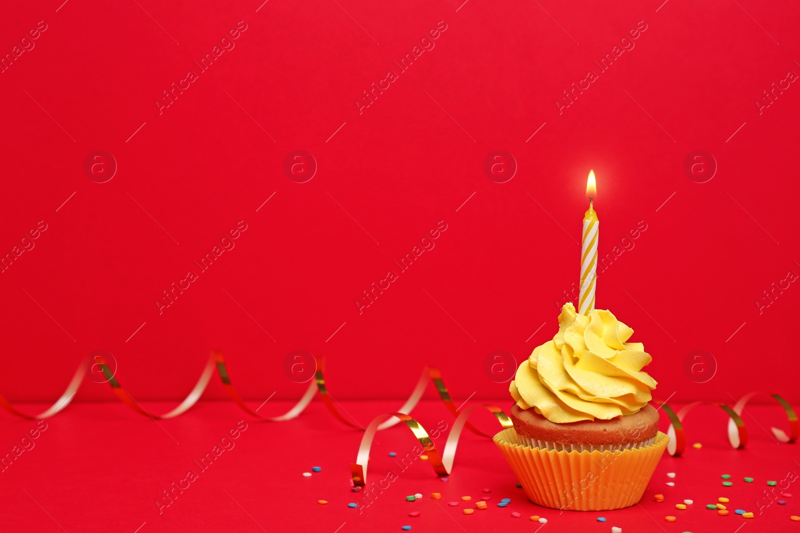 Birthday cupcake with candle on color background Photo of Birthday cupcake with candle on color background