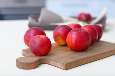 Ripe red apples on wooden board Photo of Ripe red apples on wooden board