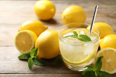 Natural lemonade with mint and fresh fruits on wooden table, closeup. Summer refreshing drink Photo of Natural lemonade with mint and fresh fruits on wooden table, closeup. Summer refreshing drink