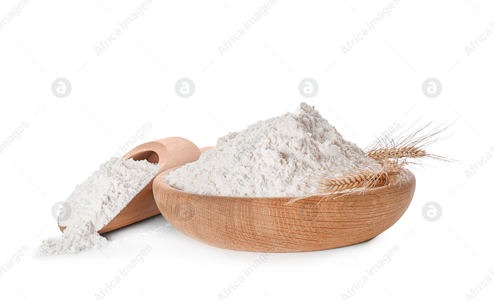 Bowl and scoop with flour on white background Photo of Bowl and scoop with flour on white background