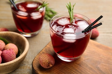 Delicious lychee cocktails on wooden table, closeup Photo of Delicious lychee cocktails on wooden table, closeup