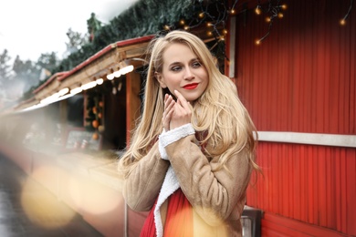 Young woman spending time at winter fair. Christmas celebration Photo of Young woman spending time at winter fair. Christmas celebration