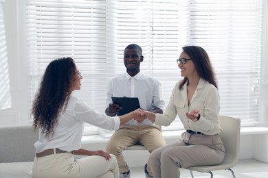 Boss shaking hands with new coworker during job interview in office Photo of Boss shaking hands with new coworker during job interview in office